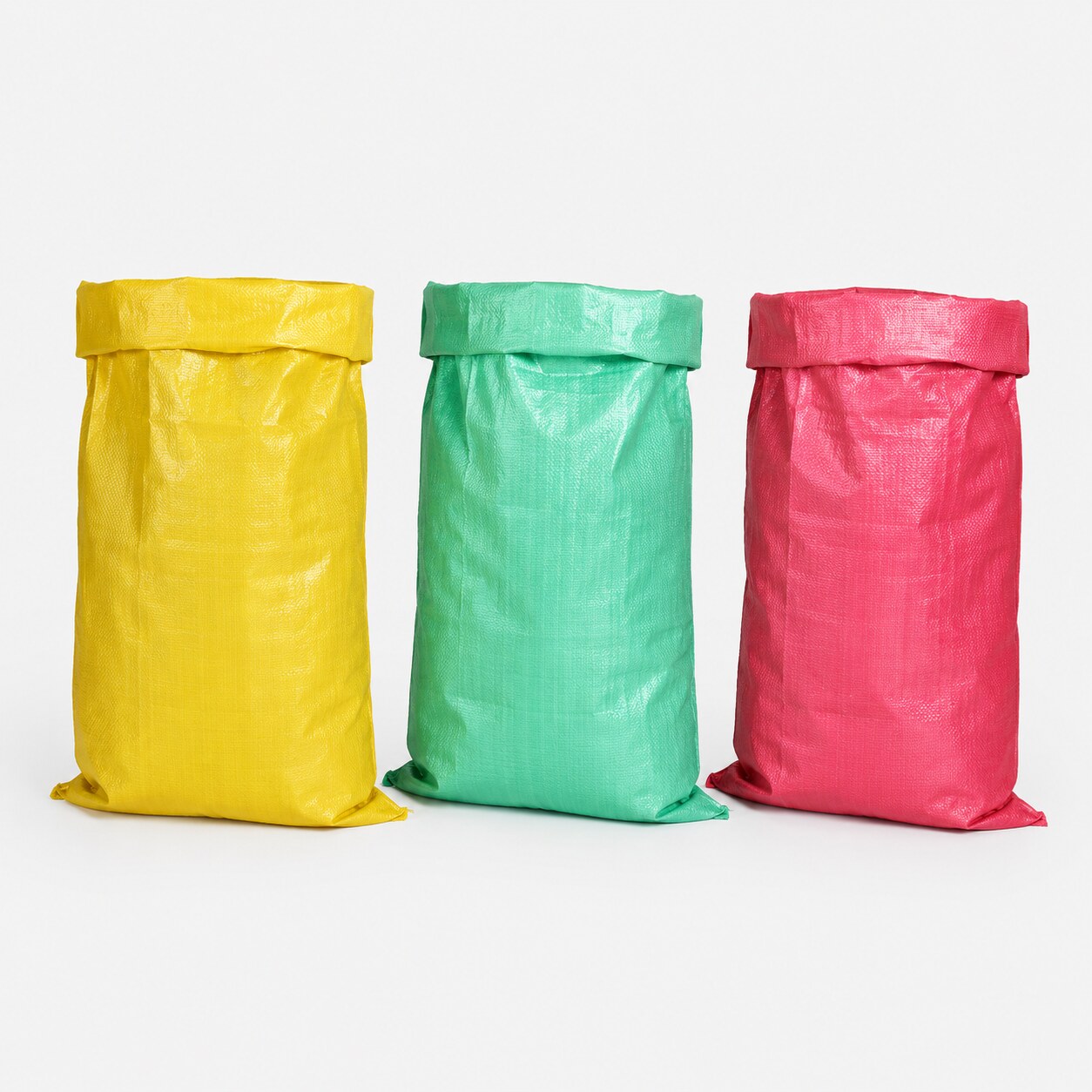 Upright filled woven sacks in different colours